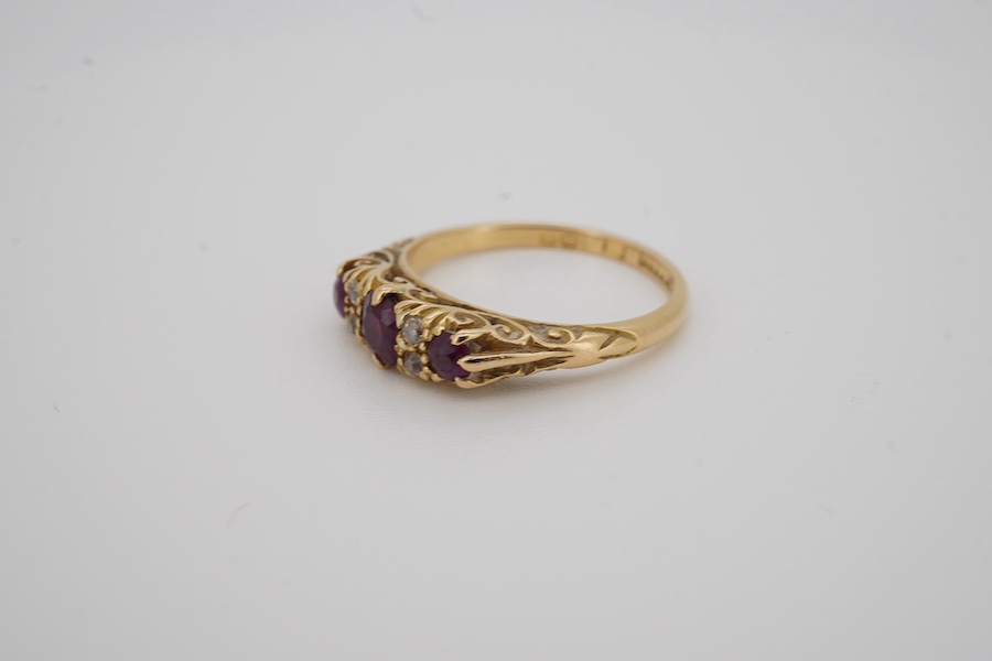 An Edwardian 18ct gold, three stone ruby and four stone diamond set half hoop ring, size K, gross weight 3.4 grams. Condition - fair